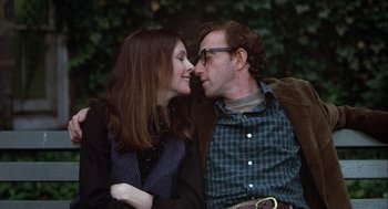 Movie still from “Annie Hall” (1977), directed by Woody Allen – A man and a woman sitting next to each other on a park bench; Close Up shot, Low angle