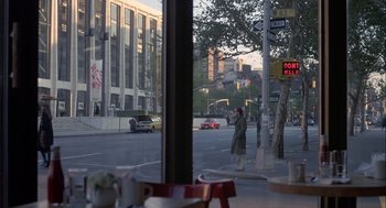 Movie still from “Annie Hall” (1977), directed by Woody Allen – A person standing on the sidewalk of a city street; Wide shot, Over the shoulder angle