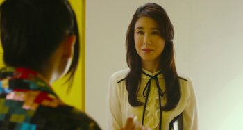 Movie still from “Antiporno” (2016), directed by Sion Sono – A woman in a white shirt is looking in the mirror; Close Up shot, Over the shoulder angle