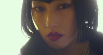 Movie still from “Antiporno” (2016), directed by Sion Sono – A woman's face with dark hair and red lipstick; Extreme Close Up shot, Low angle