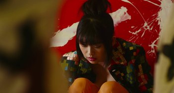 Movie still from “Antiporno” (2016), directed by Sion Sono – A woman sitting on the ground holding an umbrella; Medium shot, Low angle