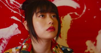 Movie still from “Antiporno” (2016), directed by Sion Sono – A person wearing a colorful shirt; Close Up shot, Low angle