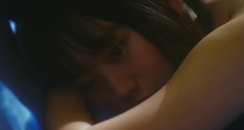 Movie still from “Antiporno” (2016), directed by Sion Sono – A child's face with her head resting on her arm; Close Up shot, High angle
