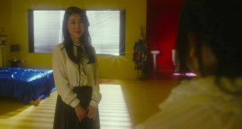 Movie still from “Antiporno” (2016), directed by Sion Sono – A young woman in a room with a window; Medium shot, Over the shoulder angle