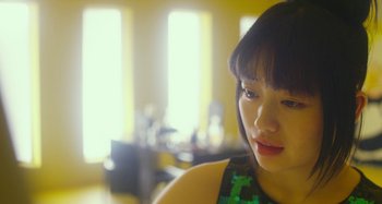 Movie still from “Antiporno” (2016), directed by Sion Sono – A person wearing a green shirt; Close Up shot, Low angle