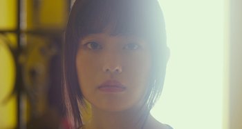 Movie still from “Antiporno” (2016), directed by Sion Sono – A young woman's face in the sunlight; Close Up shot, Low angle