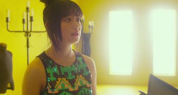 Movie still from “Antiporno” (2016), directed by Sion Sono – A woman in a black and green top looking up; Close Up shot, Low angle