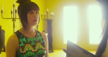 Movie still from “Antiporno” (2016), directed by Sion Sono – A young girl is looking at a mirror in a yellow room; Close Up shot, Low angle