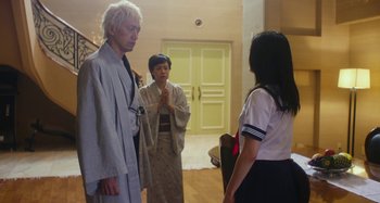 Movie still from “Antiporno” (2016), directed by Sion Sono – A man and two women standing next to each other in a room; Medium shot, Over the shoulder angle