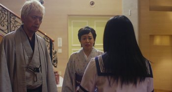 Movie still from “Antiporno” (2016), directed by Sion Sono – A woman in a kimono looking in the mirror; Medium shot, Over the shoulder angle