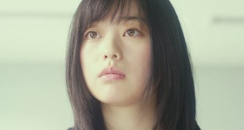Movie still from “Antiporno” (2016), directed by Sion Sono – A person with long black hair; Close Up shot, Low angle