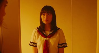 Movie still from “Antiporno” (2016), directed by Sion Sono – A young woman wearing a sailor's uniform; Medium shot, Low angle