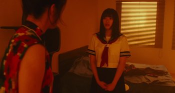 Movie still from “Antiporno” (2016), directed by Sion Sono – Two young women are standing in front of each other; Medium shot, Over the shoulder angle
