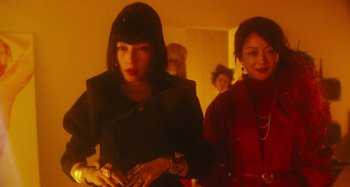 Movie still from “Antiporno” (2016), directed by Sion Sono – Two women are standing together in a room; Medium shot, Low angle