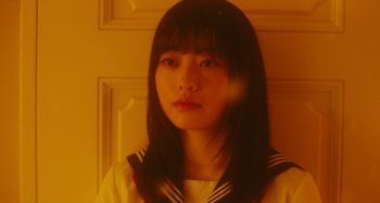 Movie still from “Antiporno” (2016), directed by Sion Sono – A young asian woman in a sailor's uniform; Close Up shot, Low angle