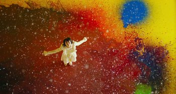 Movie still from “Antiporno” (2016), directed by Sion Sono – A young girl flying through the air while holding her arms out; Extreme Wide shot, Overhead angle