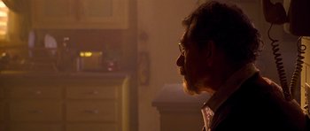 Movie still from “Apt Pupil” (1998), directed by Bryan Singer – A person with a beard and glasses; Close Up shot, Over the shoulder angle