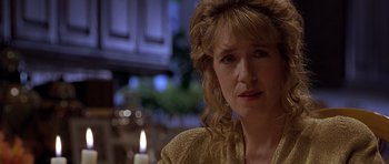 Movie still from “Apt Pupil” (1998), directed by Bryan Singer – A person with a candle in the background; Close Up shot, Over the shoulder angle