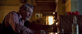 Movie still from “Apt Pupil” (1998), directed by Bryan Singer – An older man sitting at a table in front of a window; Close Up shot, Over the shoulder angle