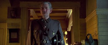 Movie still from “Apt Pupil” (1998), directed by Bryan Singer – An older man wearing a uniform and a hat; Close Up shot, Low angle