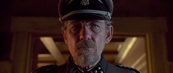 Movie still from “Apt Pupil” (1998), directed by Bryan Singer – An older man in a uniform and a hat; Close Up shot, Low angle
