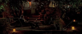 Movie still from “Apt Pupil” (1998), directed by Bryan Singer – A table and chairs in a yard at night; Wide shot, High angle