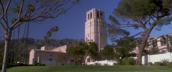 Movie still from “Apt Pupil” (1998), directed by Bryan Singer – A large building with a tall tower on top of it; Extreme Wide shot, Low angle