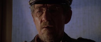 Movie still from “Apt Pupil” (1998), directed by Bryan Singer – An older man wearing a hat and glasses; Close Up shot, Low angle
