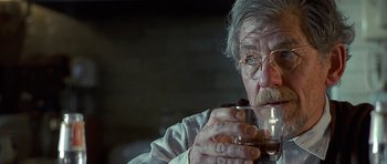Movie still from “Apt Pupil” (1998), directed by Bryan Singer – An older man drinking a glass of wine; Close Up shot, Over the shoulder angle