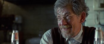 Movie still from “Apt Pupil” (1998), directed by Bryan Singer – An older man with glasses and a beard; Close Up shot, Over the shoulder angle