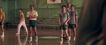 Movie still from “Apt Pupil” (1998), directed by Bryan Singer – A group of young men standing on a basketball court; Wide shot, Low angle