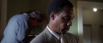 Movie still from “Apt Pupil” (1998), directed by Bryan Singer – A person wearing a suit and a tie; Close Up shot, Over the shoulder angle