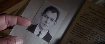 Movie still from “Apt Pupil” (1998), directed by Bryan Singer – An old black and white photo of a man in a suit; Extreme Close Up shot, High angle