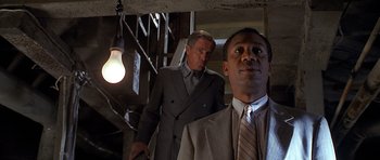 Movie still from “Apt Pupil” (1998), directed by Bryan Singer – Two men in suits and ties standing next to each other; Medium shot, Low angle
