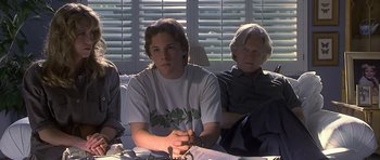 Movie still from “Apt Pupil” (1998), directed by Bryan Singer – A group of people sitting around a table; Medium shot, High angle
