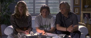 Movie still from “Apt Pupil” (1998), directed by Bryan Singer – A group of people sitting around a table; Medium shot, Over the shoulder angle