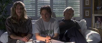 Movie still from “Apt Pupil” (1998), directed by Bryan Singer – A group of people sitting around a table; Medium shot, High angle