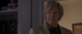 Movie still from “Apt Pupil” (1998), directed by Bryan Singer – A person wearing a suit and tie; Close Up shot, Over the shoulder angle