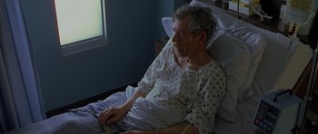 Movie still from “Apt Pupil” (1998), directed by Bryan Singer – An older man sitting in a hospital bed; Medium shot, High angle