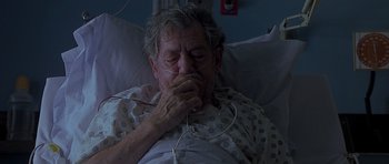 Movie still from “Apt Pupil” (1998), directed by Bryan Singer – An older man laying in a hospital bed; Close Up shot, High angle