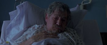 Movie still from “Apt Pupil” (1998), directed by Bryan Singer – An older man laying in a hospital bed; Close Up shot, High angle