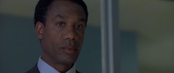 Movie still from “Apt Pupil” (1998), directed by Bryan Singer – A person wearing a suit and tie; Close Up shot, Low angle