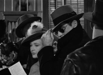 Movie still from “Arsenic and Old Lace” (1944), directed by Frank Capra – A group of people wearing hats and sunglasses; Close Up shot, Over the shoulder angle