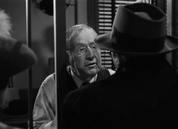 Movie still from “Arsenic and Old Lace” (1944), directed by Frank Capra – An older man wearing glasses and a hat; Close Up shot, Over the shoulder angle
