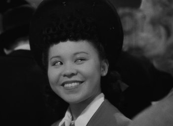 Movie still from “Arsenic and Old Lace” (1944), directed by Frank Capra – A black and white photo of a young girl wearing a hat; Close Up shot, High angle