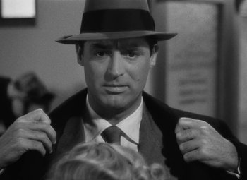 Movie still from “Arsenic and Old Lace” (1944), directed by Frank Capra – A black and white photo of a man wearing a hat; Close Up shot, Over the shoulder angle