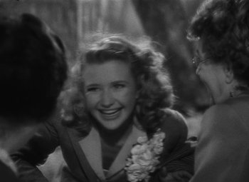 Movie still from “Arsenic and Old Lace” (1944), directed by Frank Capra – An old photo of a woman smiling at the camera; Close Up shot, Over the shoulder angle