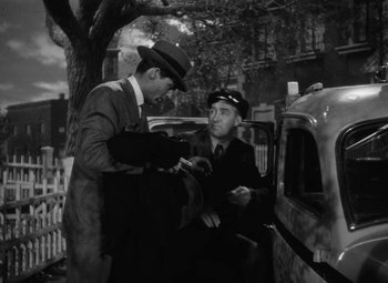 Movie still from “Arsenic and Old Lace” (1944), directed by Frank Capra – Two men standing next to each other in front of a car; Medium shot, Low angle