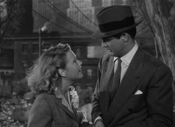 Movie still from “Arsenic and Old Lace” (1944), directed by Frank Capra – A man and a woman standing next to each other in front of a building; Medium shot, Low angle