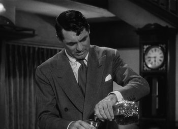 Movie still from “Arsenic and Old Lace” (1944), directed by Frank Capra – A black and white photo of a man pouring something into a glass; Medium shot, Over the shoulder angle